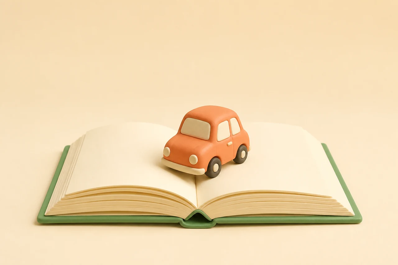DriveTheory: a small car on an open theory book.